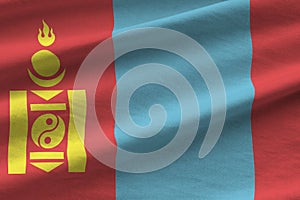 Mongolia flag with big folds waving close up under the studio light indoors. The official symbols and colors in banner photo