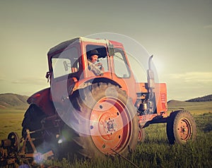 Mongolian Farmer Driving Tractor Field Agicultural Concept