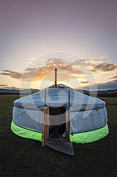 Mongolian ger in the middle of the steppe at sunset