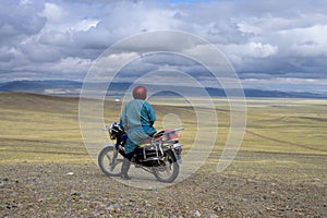 Mongolian on a motorcycle