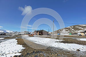 Mongolian village in the snowy steppe. The border area from Mongolia. Realistic village life. Authentic village, houses in the