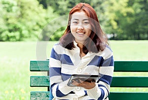 Mongolian woman sitting on a bench