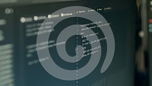 Monitor display of software developer typing database functions script