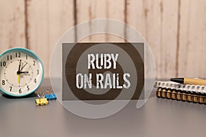 Monitor in modern office with text RUBY ON RAILS on the screen