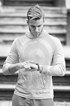 Monitoring heart rate from your wrist. Athletic man check watch. Handsome athlete use smart watch. Fitness tracking