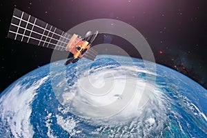 Monitoring hurricane. Satellite above the Earth makes measurements of the weather parameters and movement trajectory forecast.