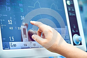 Monitoring patient`s vital sign in operating room. doctor cheking at patient`s vital signs. Cardiogram monitor during