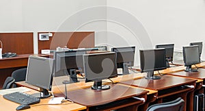 The monitors are on the tables in the computer classroom of the university