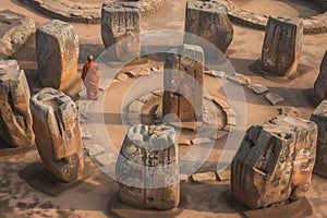 monk in the center of a stone circle, akin to stonehenge