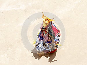 Monk in deer mask performs a religious masked and costumed mystery dance of Tibetan Buddhism on the Cham Dance Festival