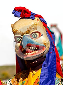 Monk in Garuda mask bird-like creature in Hindu, Buddhist and Jain mythology performs religious mystery dance of Tibetan Buddhis