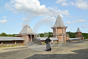 The monk goes across the territory of the Sacred and Troitsk Trifonov-Pechengsky man's monastery