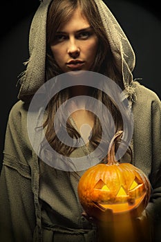 Monk holding halloween pumpkin