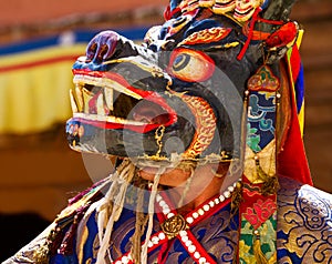 Monk in mask performs a sacred dance during the Cham Dance Festival