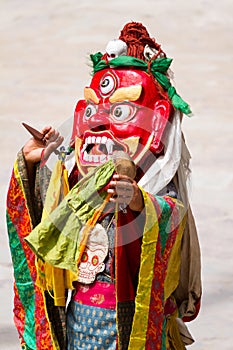 Monk in mask and with with phurpa (ritual knife) performs a sacred dance of Tibetan Buddhism