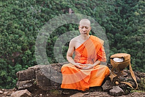 Monk meditating on top of a mountain, Purify the mind photo