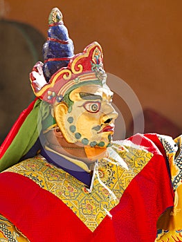 Monk performs a masked and costumed sacred dance of Tibetan Buddhism on the Cham Dance