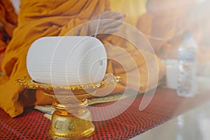 A monk prays with the holy thread in the Buddhists Auspicious ceremony.