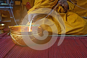 A monk prays with the holy water in the Buddhists Auspicious ceremony.