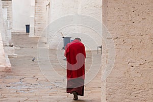 Monk in red robes in a monastery in Punakha, Bhutan