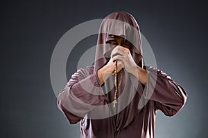 The monk in religious concept on gray background
