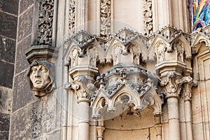 Monk`s face and other details on the facade of Basilica of St.Peter and St. Paul