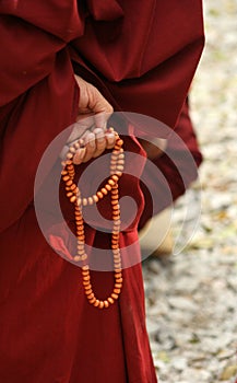 Monk's hand with bead