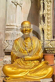 Monk statue sitting under sunlight