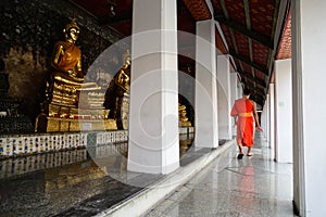 A monk walk in a temple in peaceful moment ,Bangkok,Thailand.