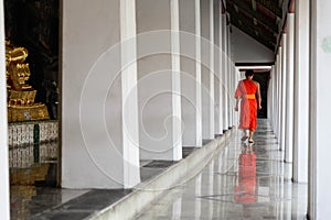 A monk walk in a temple in peaceful moment ,Bangkok,Thailand.