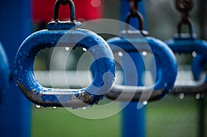 Monkey bars rings on a school playground at rainy day