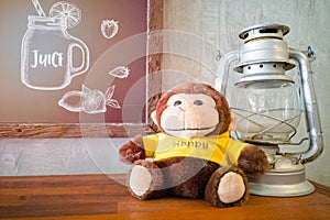 Monkey doll and black board with wooden border