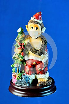 Monkey figure with Christmas toys. Monkey since ancient times is considered the embodiment of agility and cunning.