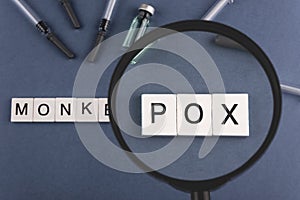 MONKEY POX concept. The word POX is visible through a magnifying glass. Viral disease photo
