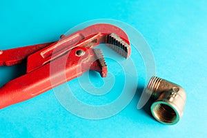 A monkey wrench on the blue background with some fitting connectors. for design and decoration
