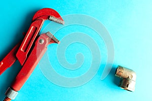 A monkey wrench on the blue background with some fitting connectors. for design and decoration