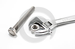 Monkey wrench and bolt and nut on white background