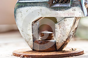 Monkey wrench and old bolt nut