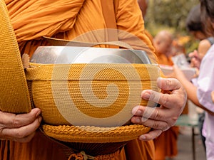 The monks of the Buddhist Sangha give alms to a Buddhist monk, which came out of the Buddhist offerings in the morning. The photo