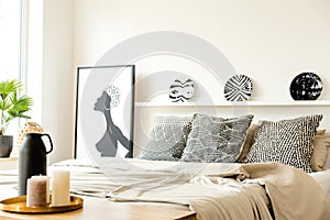 Monochromatic bedroom interior with poster