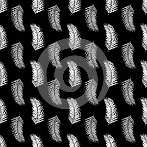 Monochrome abstract feathers seamless vector pattern. White feather shapes on black background. Abstract palm leaves