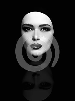 Monochrome art fashion portrait of beautiful woman face like a mask