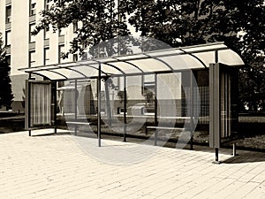 Monochrome bus shelter with blank poster and billboard advert with light box