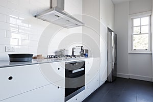 Monochrome clean white kitchen benchtop with appliances