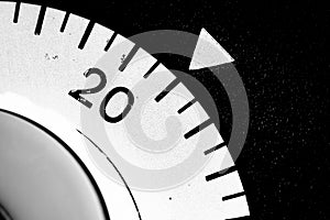 monochrome close-up of an old analog laboratory timer set to 21