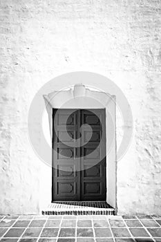 Monochrome doors in a stucco building