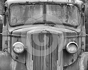 monochrome front view of an old abandoned rusty 1940s truck
