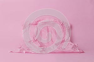 Monochrome image with blank space on crumpled paper on a pink background for your product. Pastel shades. Minimal concept