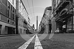 Monochrome street view in Bologna with the Asinelli Towers photo