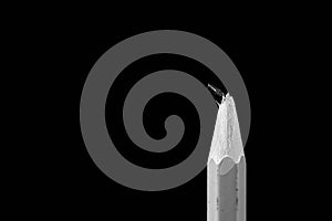 Monochrome image of a broken pencil close up macro shot on black background